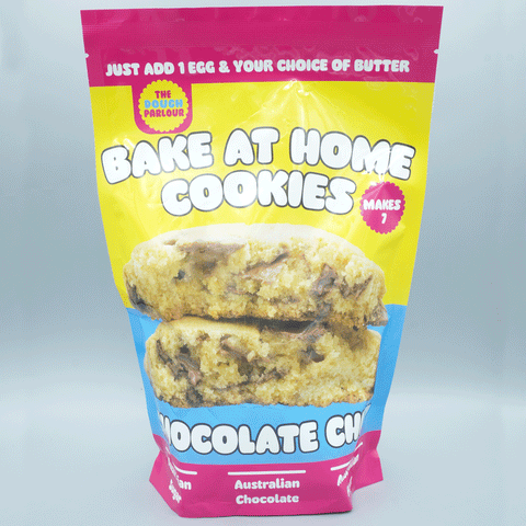 The Dough Parlour Signature Chocolate Chip Cookie Premix pouch with freshly baked cookies.