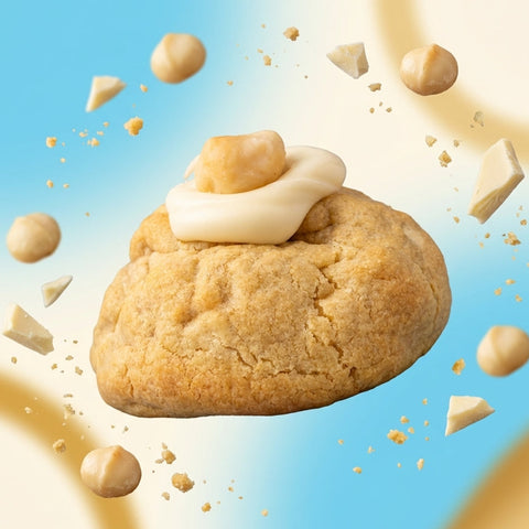 Thick New York style white chocolate macadamia cookie with a molten white chocolate ganache core and a whole toasted macadamia nut on top.