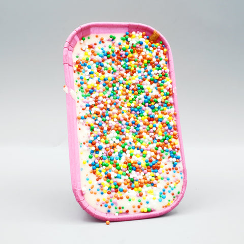 Dot Cookie Boat by The Dough Parlour: soft-baked cookie with white chocolate ganache covered in rainbow dot sprinkles in a pink paper boat